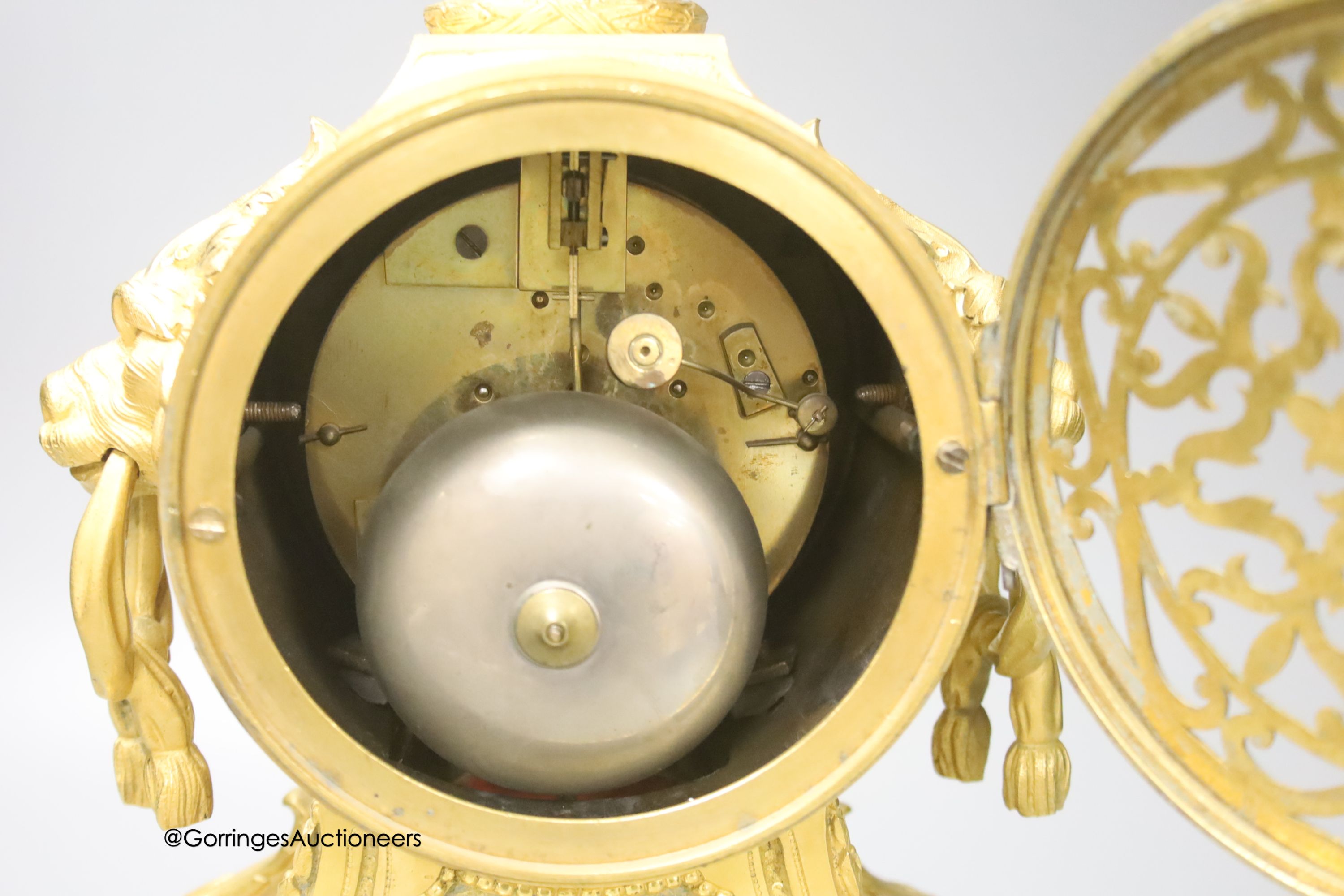 A 19th century French ormolu clock, with lion mask ring handles, 34cm